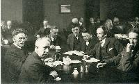 Portrait of Barker Fairley: Left to right - Fred Varley, A.Y.Jackson, Lawren Harris, Barker Fairley (pipe in mouth), Frank Johnston, Arthur Lismer, J.E.H. Macdonald  (c. 1920)