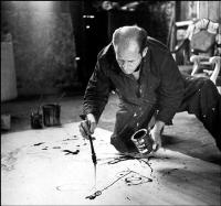 Portrait of Jackson Pollock: Jackson Pollock dripping onto his canvas in 1949.