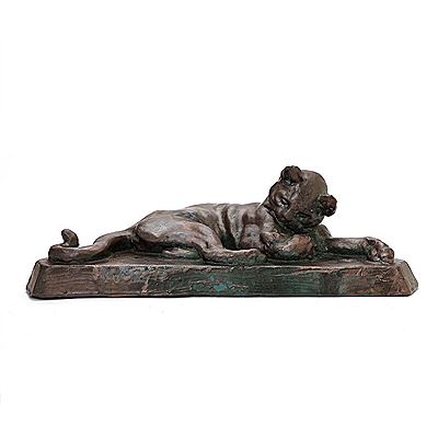 Lying cat on a plinth
