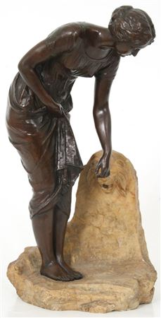 Sculpture of a woman standing next to a lion head fountain