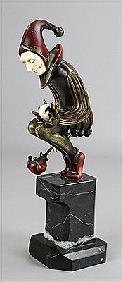 Jester, crouching while holding a Carnival mask and crown