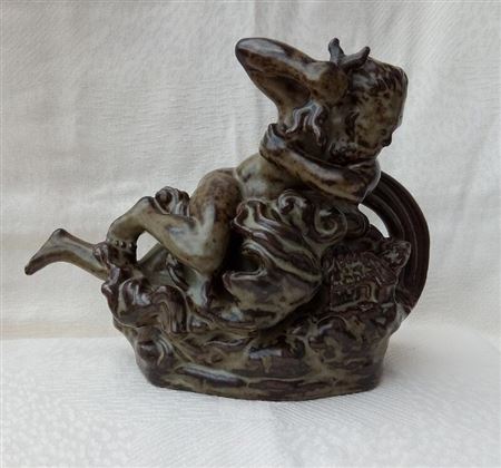 A stoneware figure in the shape of Thor, the god of thunder
