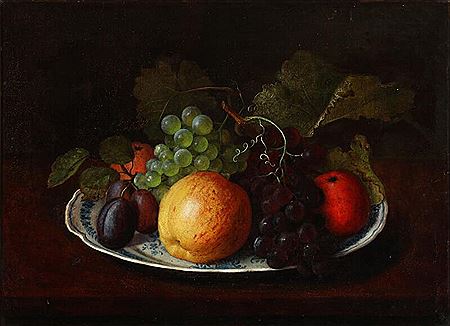 Still life with apples, plums, and grapes on an earthenware dish.