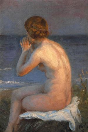 A nude female sitting on the beach at sunset.