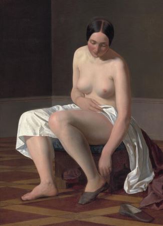 A female nude putting on her slippers