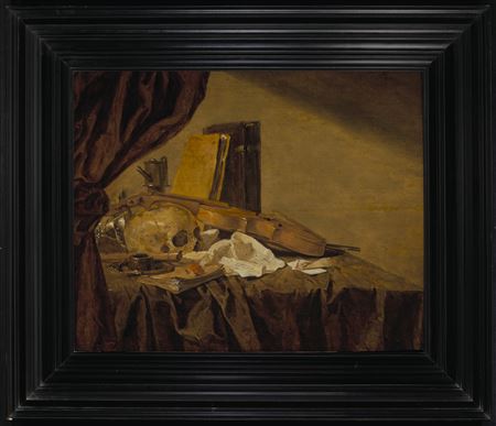 A vanitas still life with a skull, musical instruments, books, playing cards, an ink pot, an overturned tazza and an oil lamp on a draped table behind a partially pulled curtain