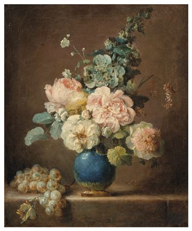 Vase of flowers and grapes on a stone ledge