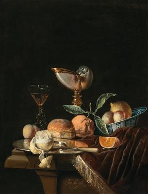 A Nautilus cup, a Wan-Li Kraak porcelain bowl with mixed fruit, a silver salver and a glass of wine on a stone table with a velvet cover