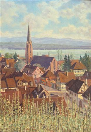 View over grapevines to a town with a church on a river