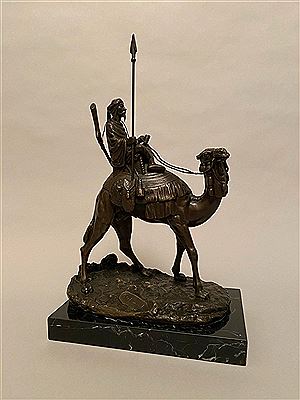 The camel driver riding a dromedary