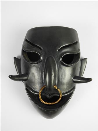 Africanist mask in black ceramic and gilded twisted metal.