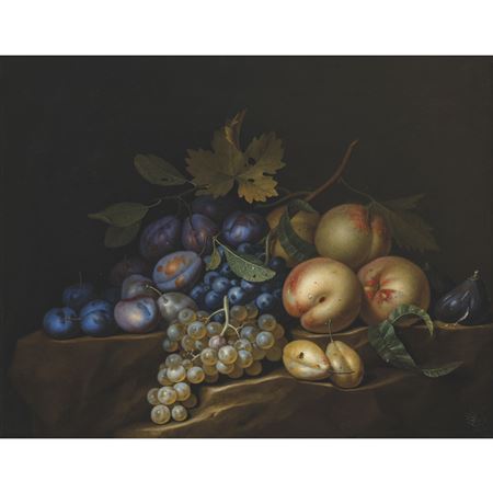 Plums, peaches and grapes on a rocky ledge