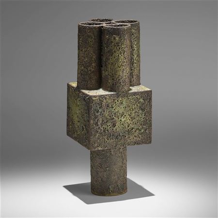 Large cube with four pipes on a cylindrical base