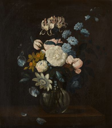 Still life with roses, honeysuckle, passion flower, daffodils and other flowers in a glass vase on a ledge