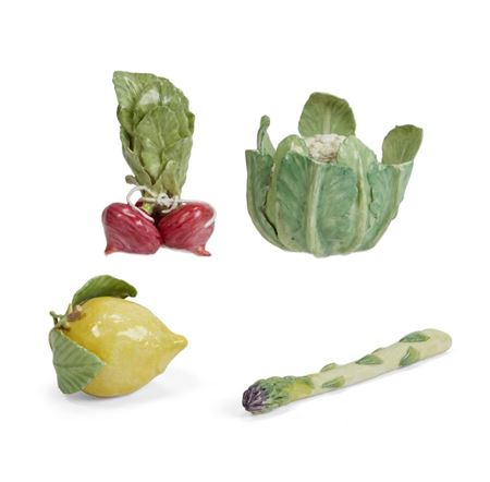 A group of four porcelain models of fruit and vegetables