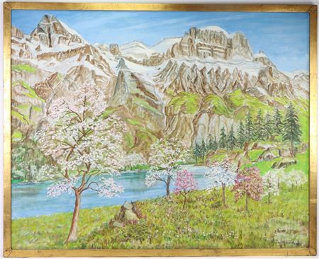 Spring landscape with flowering trees and snow-capped mountains in the distance