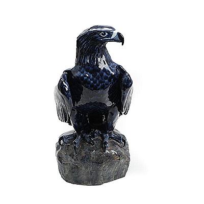 Golden eagle, seated on a rock.