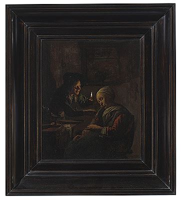 A young boy holding a candle teasing a sleeping woman