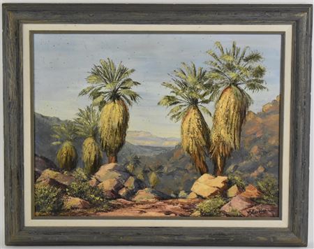 A group of palm trees amongst a rocky mountain landscape
