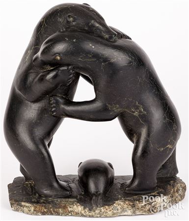 Two bears fighting over a seal