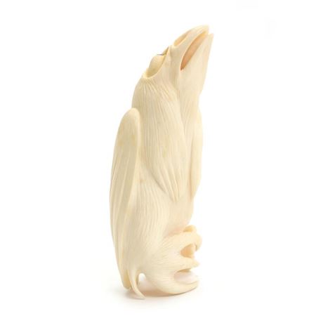 A carved sperm whale tulipak figurine.