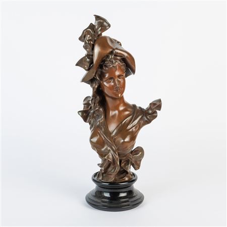 A bronze sculpture of a young woman with hat