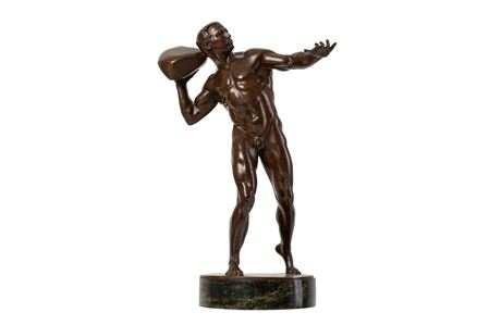 Male nude athlete preparing to throw a stone