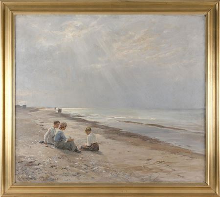 Three girls seated on the beach.