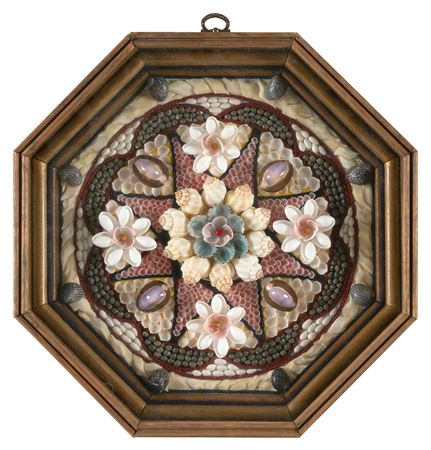 Sailor's valentine composed of multicolored shells in a compass rose design,