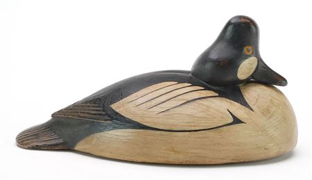 Early goldeneye with tucked head and relief wing and tail feather carving