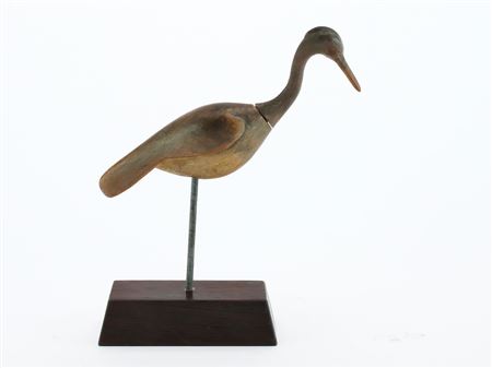 Miniature heron with relief wing carving and slightly turned head with extended crest.