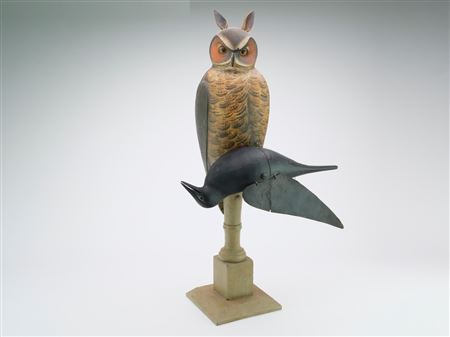 Very rare owl mounted on base with dead crow that has a mechanical flapping wing.