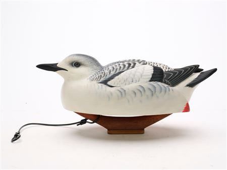 Hollow carved seabird and collector's edition book titled "The Art in Making Decoys"