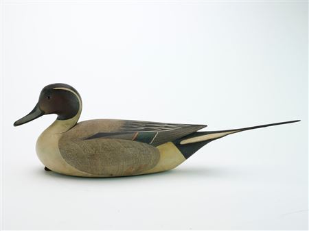 Hollow carved pintail with raised wing tips, extended tail, and fine comb feather paint detail.