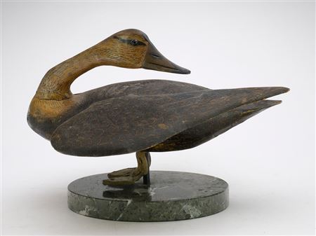 Decorative standing black duck with applied outstretched wings and elongated, turned neck.