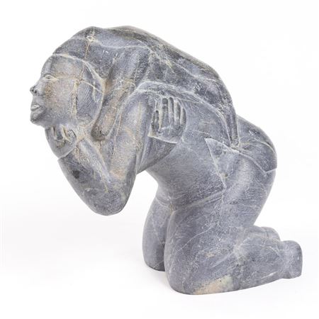 FIGURE OF A KNEELING MAN WITH A DOG ON HIS BACK