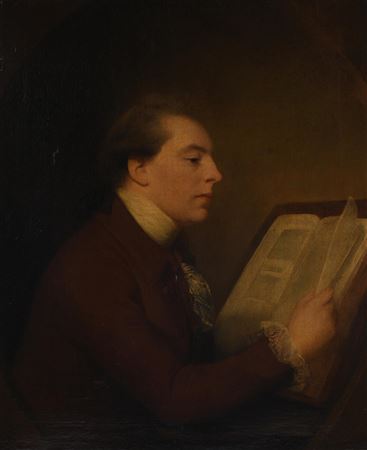 GENTLEMAN SEATED READING A BOOK