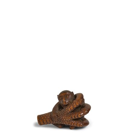 A Wood Netsuke of a Monkey Trapped in a Falcon's Claws