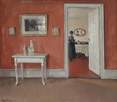 Interior from a red livingroom with a woman seen from the back
