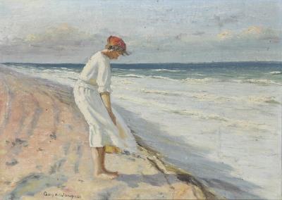 A woman wearing a white dress standing on the beach