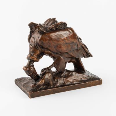 A bronze sculpture of a vulture with prey