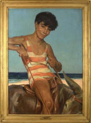 A boy riding a donkey