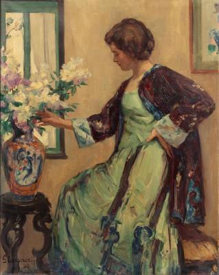 Lady in an interior near a porcelain vase with flowers
