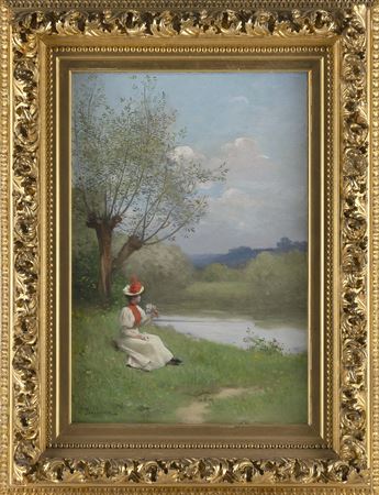 Girl seated by the water's edge.