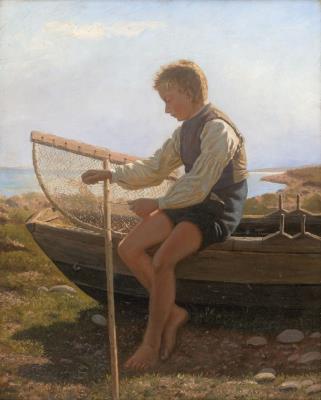 Boy with fish trap on the beach