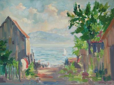 View through houses onto Lake Constance with sailing boat