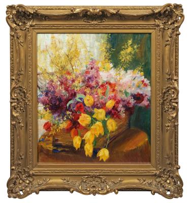 Spring still life with tulips and forsythia in a chip basket