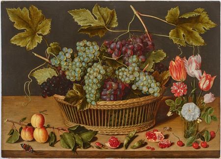 Basket of grapes with a peach branch and a bouquet of flowers