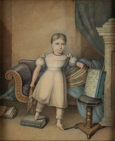 Portrait of a child in an interior with sofa, stool and books