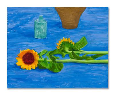 Two Sunflowers Laying on a Table